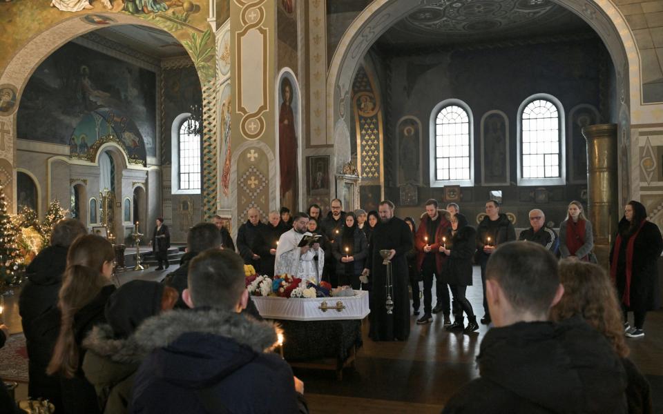 Relatives and friends attend the funeral of Lyudmyla Shevtsova, an 84-year-old scientist killed in her apartment by a Russian missile