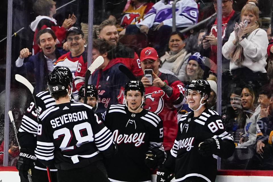 New Jersey Devils' Jack Hughes (86) celebrates with teammates after scoring a goal against the St. Louis Blues during the second period of an NHL hockey game Thursday, Jan. 5, 2023, in Newark, N.J. (AP Photo/Frank Franklin II)