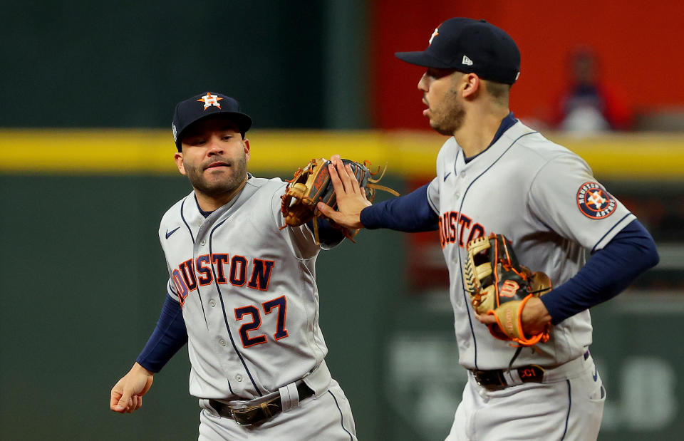 ATLANTA, GEORGIA - OCTOBER 30:  Jose Altuve #27 and Carlos Correa #1 of the Houston Astros celebrate a double play against the Atlanta Braves during the fourth inning in Game Four of the World Series at Truist Park on October 30, 2021 in Atlanta, Georgia. (Photo by Kevin C. Cox/Getty Images)