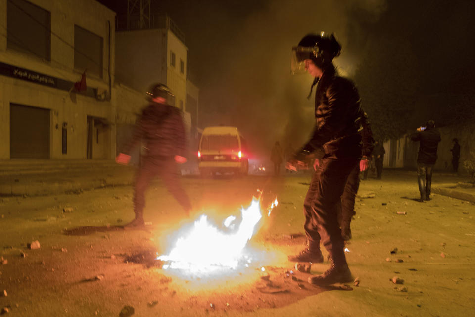 <p>Riot police hold their positions near a fire after clashes with demonstrators in Tebourba, south of the Tunisian capital, Tunis, Jan. 9, 2018. (Photo: Amine Landoulsi/AP) </p>