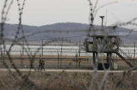 South Korean army soldiers patrol along the barbed-wire fence in Paju, South Korea, near the border with North Korea, Monday, March 13, 2023. North Korea test-fired a few short-range ballistic missiles toward its eastern waters Tuesday in Pyongyang's second show of force this week, officials said, a day after the beginning of U.S.-South Korean military drills that the North views as an invasion rehearsal. (AP Photo/Ahn Young-joon)