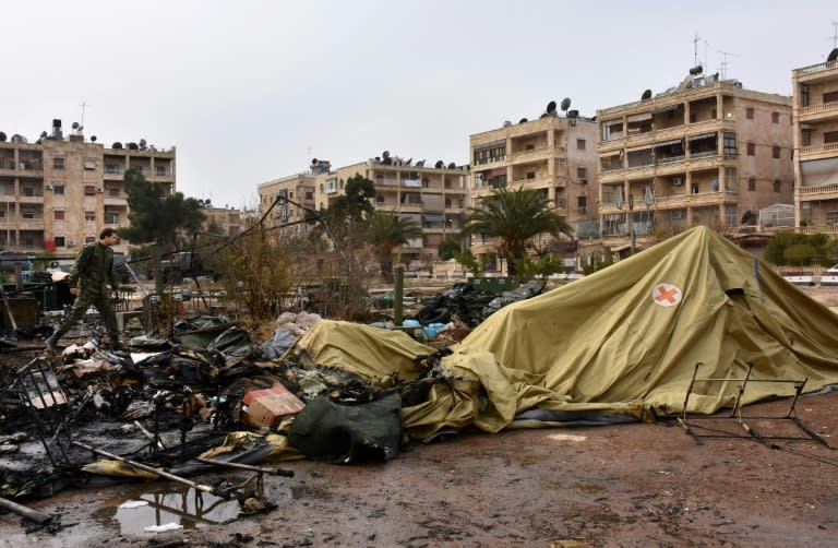 A Russian soldier inspects the damage at a field hospital that was reportedly destroyed by rebel shelling in the Furqan neighbourhood of the government-held side of west Aleppo