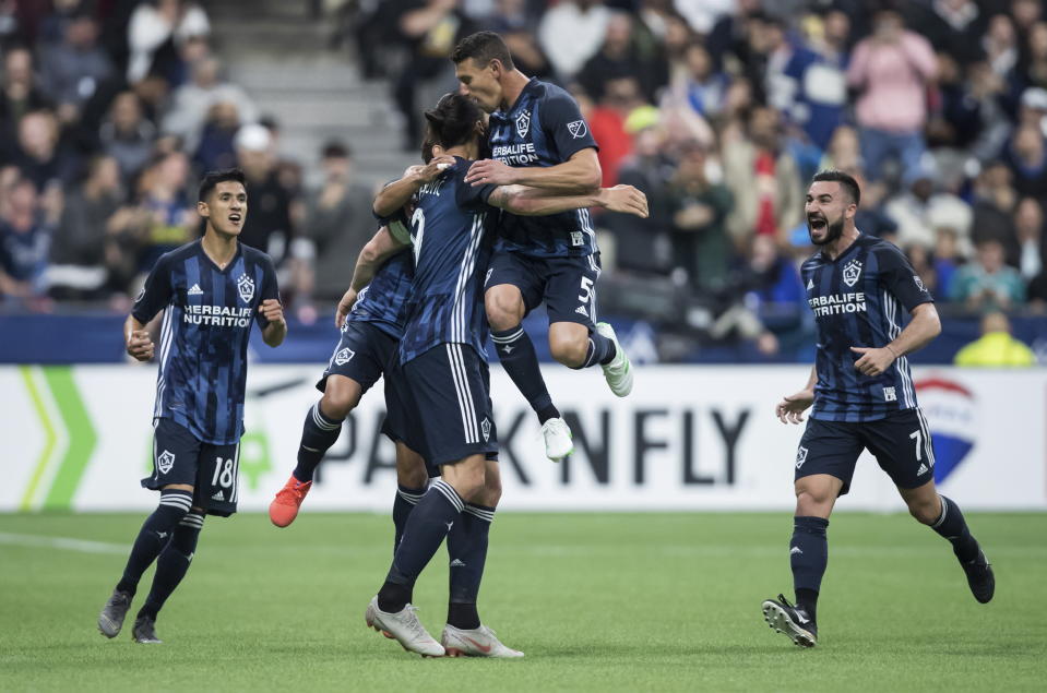LA Galaxy's Uriel Antuna, Jonathan dos Santos, back, Zlatan Ibrahimovic, Daniel Steres and Romain Alessandrini, from left, celebrate Ibrahimovic's goal against the Vancouver Whitecaps during the second half of an MLS soccer match Friday, April 5, 2019, in Vancouver, British Columbia. (Darryl Dyck/The Canadian Press via AP)