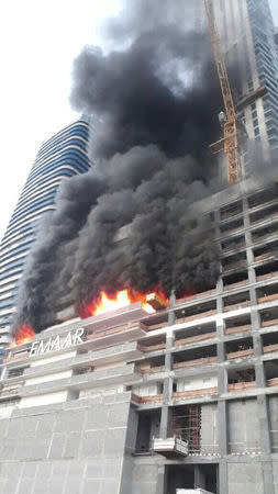 A fire is seen at a tower under construction in Dubai's Downtown district, United Arab Emirates April 2, 2017. Government of Dubai Media Office/Handout via REUTERS