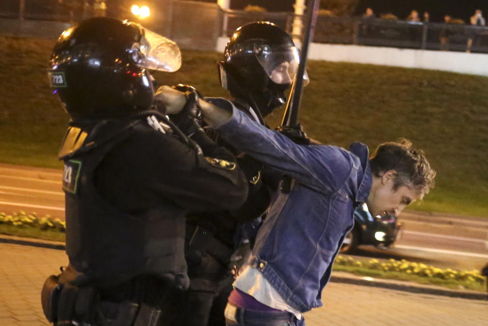 Riot police detain a protester during an opposition rally to protest the presidential inauguration in Minsk, Belarus, Wednesday, Sept. 23, 2020. Belarus President Alexander Lukashenko has been sworn in to his sixth term in office at an inaugural ceremony that was not announced in advance amid weeks of huge protests saying the authoritarian leader's reelection was rigged. Hundreds took to the streets in several cities in the evening to protest the inauguration. (AP Photo/TUT.by)