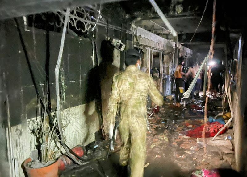 A member of Iraqi security forces walks at Ibn Khatib hospital after a fire caused by an oxygen tank explosion in Baghdad