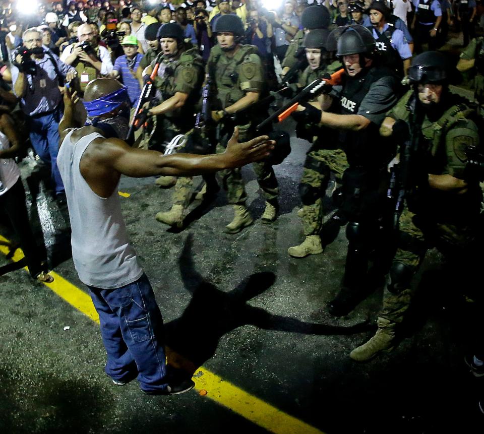 Police arrest a man as they disperse a protest in Ferguson, Missouri, on Aug. 20, 2014. On Aug. 9, a white police officer fatally shot 18-year-old Michael Brown, who was black, in the St. Louis suburb.