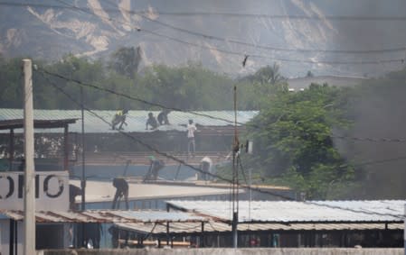 Protesters loot a police station during a demonstration demanding the resignation of Haitian President Jovenel Moise in Port-au-Prince