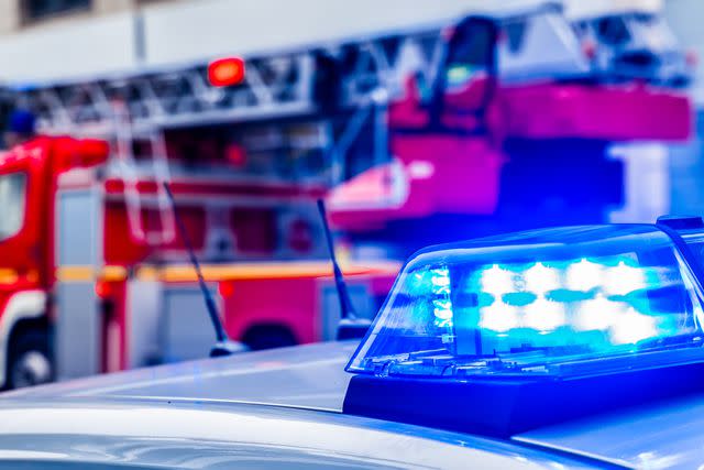 <p>Getty</p> Stock image of blue flash light of police car against red fire truck