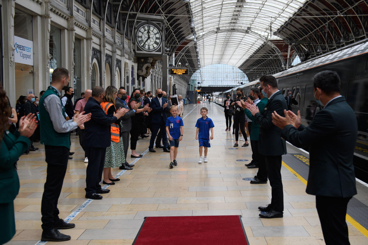 Henry and fellow fundraiser Lincoln are applauded by GWR staff. 