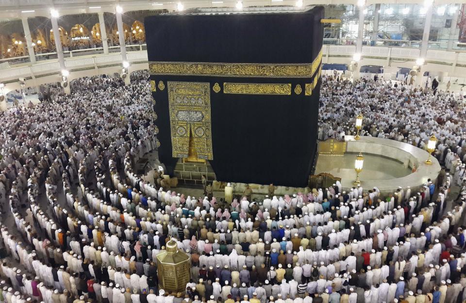 Muslims attend al-Isha prayer around Kaaba during Umrah Mawlid al-Nabawi pilgrimage, in Mecca