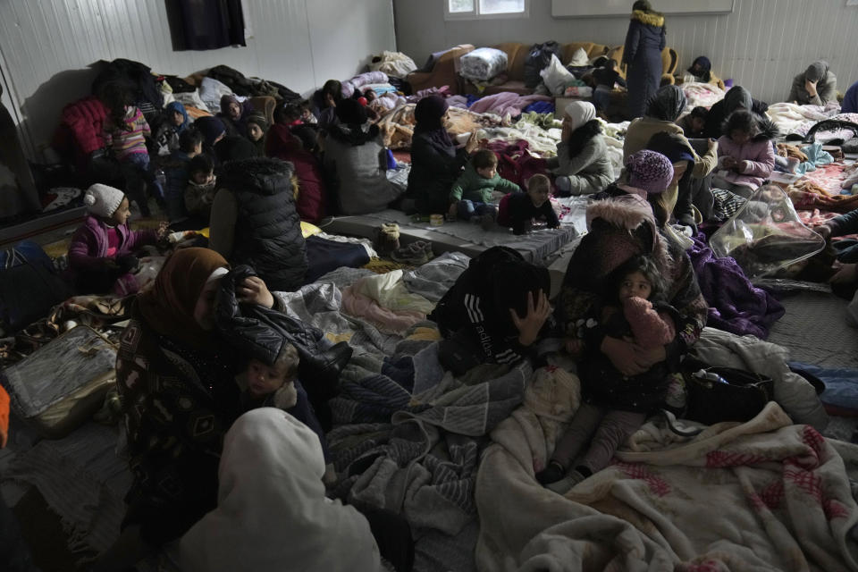 FILE Syrians gather at a shelter in Antakya, southeastern Turkey, Friday, Feb. 10, 2023. For Syrians and Ukrainians fleeing the violence back home, the earthquake that struck in Turkey and Syria is but the latest tragedy. The U.N. says Turkey hosts about 3.6 million Syrians who fled their country’s 12-year civil war, along with close to 320,000 people escaping hardships from other countries. (AP Photo/Hussein Malla, File)