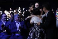 Members of Kitkit School embrace after winning the XPRIZE for Children's Literacy, Wednesday, May 15, 2019, in Los Angeles. (AP Photo/Marcio Jose Sanchez)