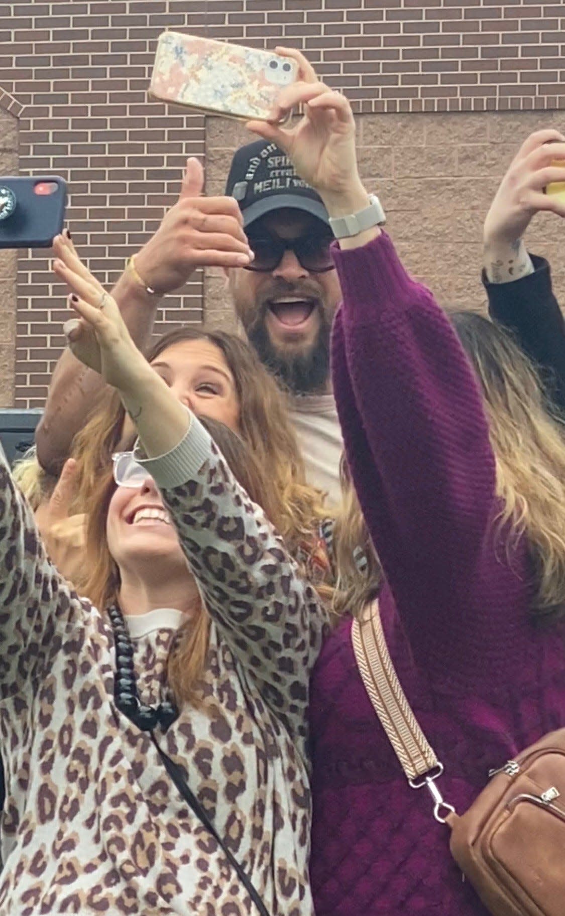 Jason Momoa takes selfies with fans outside Brookfield's Total Wine & More on Thursday. Momoa came to town to promote his new premium vodka brand, Meili, with co-founder and friend Blaine Halvorson.