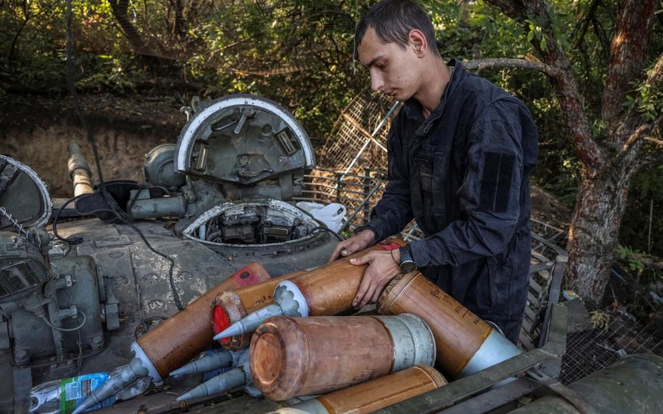 A Ukrainian serviceman prepares tank's shells