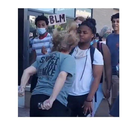 A lawyer for Eric Lucas, in the white shirt wearing a backpack, say this photo shows Shorewood lawyer Stephanie Rapkin spitting on him during a protest on June 6, 2020, on Oakland Avenue in Shorewood. Rapkin faces a disorderly conduct charge and says she spat at the ground.