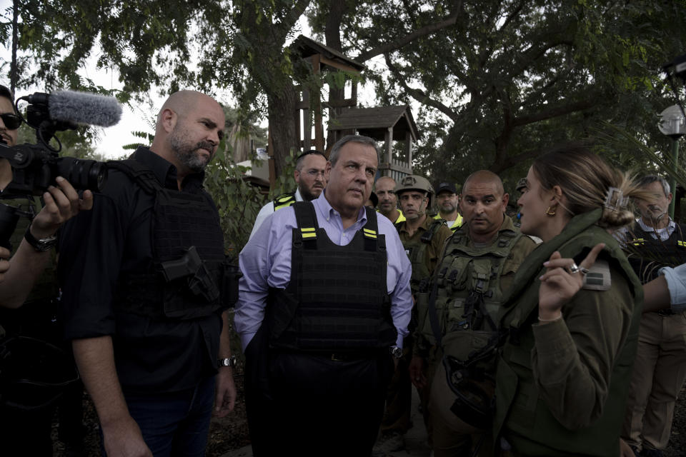 Former New Jersey Governor Chris Christie, center, visits Kibbutz Kfar Azza, near the Israel-Gaza Border, the site of an Oct. 7 massacre by Hamas, with Israel's Knesset Speaker Amir Ohana, left, Sunday, Nov. 12, 2023. (AP Photo/Maya Alleruzzo)