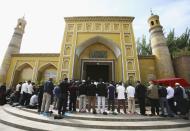 <b>KASHI, CHINA: </b>Muslims pray outside a mosque in Kashi of Xinjiang Uygur Autonomous Region, northwest China. Kashi is an oasis city which has been noted in ancient times along the old silk road as a political and commercial centre. It is the hub of an important commercial district, bordering Russia, Afghanistan, Kazakhstan, Tajikistan, Kyrgyzstan and Uzbekistan with Pakistan to its south. The Islamic Uygur ethnic minority group constitutes the majority of its population.