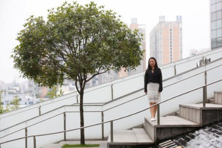 Qin Lijuan, a senior wealth management consultant and manager at CreditEase, poses for pictures in Chengdu, Sichuan province, China, September 13, 2017. Picture taken September 13, 2017. REUTERS/John Ruwitch