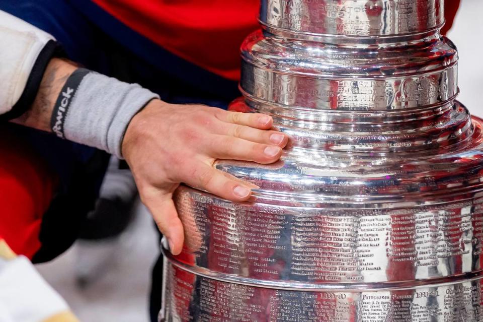 Florida Panthers defenseman Dmitry Kulikov (7) touches the Stanley Cup