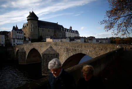 Retired people walk in front of the Old Castle in Laval, France, November 8, 2018. Picture taken November 8, 2018. REUTERS/Stephane Mahe