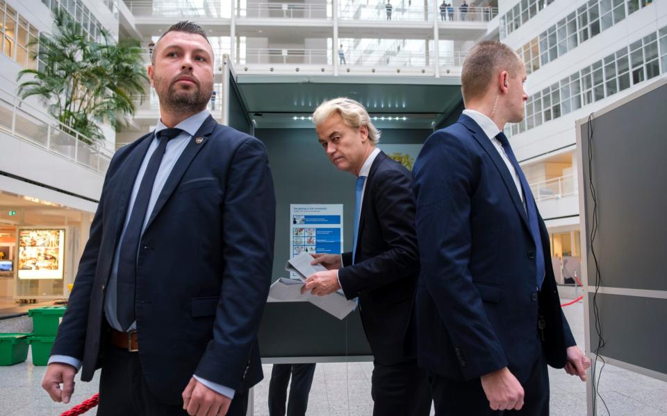Geert Wilders, centre, casts his ballot in The Hague on Wednesday