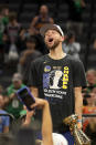 Golden State Warriors guard Stephen Curry celebrates with the Bill Russell Trophy for most valuable player after the Warriors defeated the Boston Celtics in Game 6 to win basketball's NBA Finals, Thursday, June 16, 2022, in Boston. (AP Photo/Steven Senne)