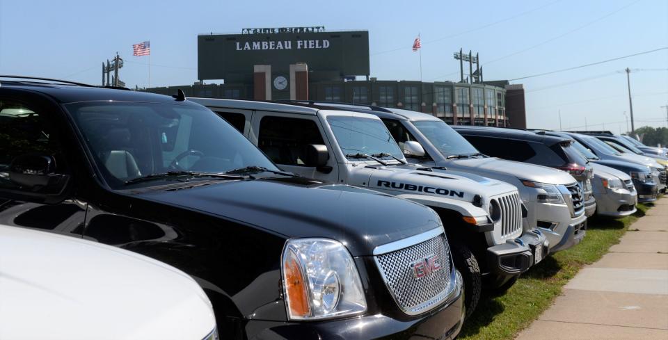 Vehicles in a line in a private lot near Lambeau Field before the preseason game on Aug. 19, 2023 in Green Bay, Wis.