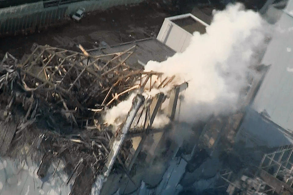 FILE - In this March 16, 2011, file photo released by Tokyo Electric Power Co. via Kyodo News, smoke billows from wrecked unit 3 at Fukushima Dai-ichi nuclear power plant in Okuma town, Fukushima prefecture, northeastern Japan. A Japanese court will decide Thursday, Sept. 19, 2019, whether three former executives for Tokyo Electric Power Co. are liable for the 2011 Fukushima meltdowns, the only criminal trial in the nuclear disaster that has kept tens of thousands of residents away from their homes due to lingering radiation contamination. (Tokyo Electric Power Co./Kyodo News via AP, File)