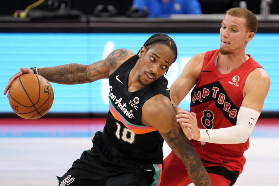 San Antonio Spurs forward DeMar DeRozan (10) drives around Toronto Raptors guard Malachi Flynn (8) during the second half of an NBA basketball game Wednesday, April 14, 2021, in Tampa, Fla. (AP Photo/Chris O'Meara)