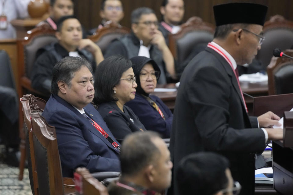 From left, Indonesian Coordinating Minister for Economics Airlanga Hartarto, Finance Minister Sri Mulyani Indrawati and Social Affairs Minister Tri Rismaharini listen as Coordinating Minister for Human Development and Cultural Affairs Muhadjir Effendy delivers his statement during a hearing on the presidential election result dispute at the Constitutional Court in Jakarta, Indonesia, Friday, April 5, 2024. (AP Photo/Dita Alangkara)