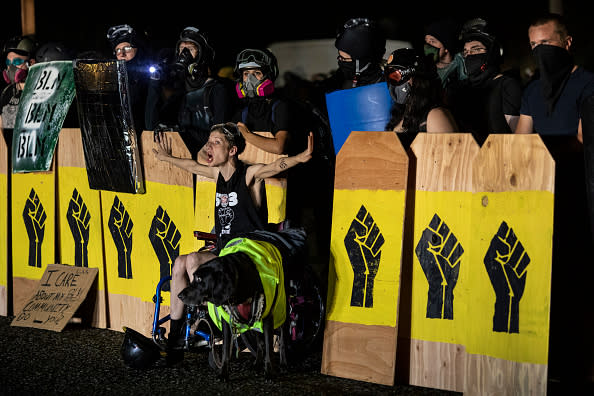 A handicapped protester screams at police during a standoff at a Portland precinct on August 15. Source: Getty