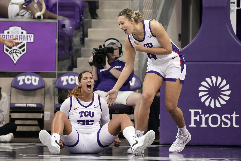 TCU's Sydney Harris (25) and Sarah Sylvester (4) celebrate a stop against Central Florida on Tuesday. (AP Photo/Tony Gutierrez)