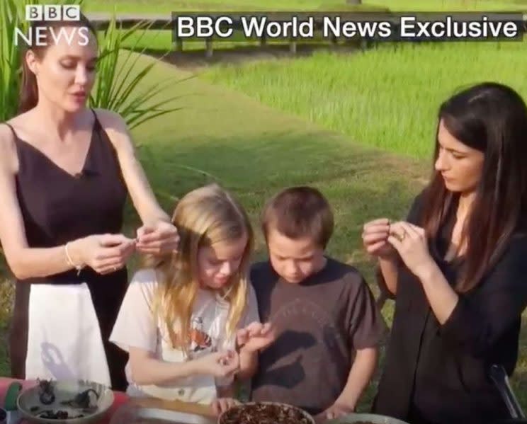 Jolie, Vivienne, and Knox try some local cuisine. BBC