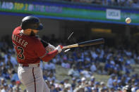 Arizona Diamondbacks' Christian Walker breaks his bat as he pops out during the seventh inning of a baseball game against the Los Angeles Dodgers Wednesday, May 18, 2022, in Los Angeles. (AP Photo/Mark J. Terrill)