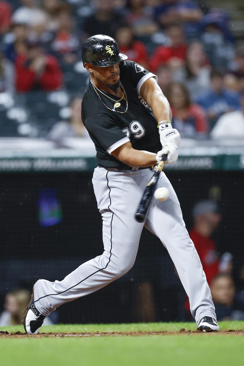 Chicago White Sox's Jose Abreu hits a one-run double off Cleveland Guardians starting pitcher Shane Bieber during the sixth inning of a baseball game Saturday, Aug. 20, 2022, in Cleveland. (AP Photo/Ron Schwane)