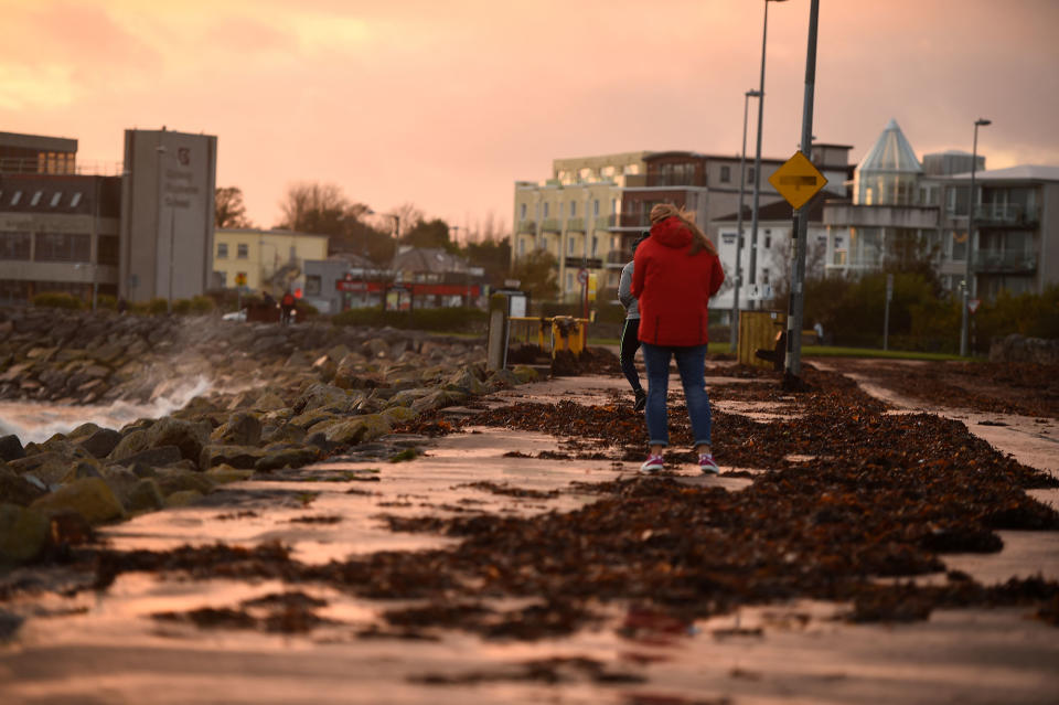 <p>People walk on a seaweed-covered path during Storm Ophelia in Galway, Ireland, Oct.16, 2017. (Photo: Clodagh Kilcoyne/Reuters) </p>