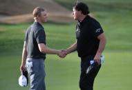 Jan 20, 2019; La Quinta, CA, USA; Adam Long (left) and Phil Mickelson shake hands following the final round of the Desert Classic golf tournament at PGA West - Stadium Course. Mandatory Credit: Orlando Ramirez-USA TODAY Sports