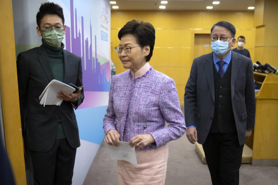 Hong Kong Chief Executive Carrie Lam, center, leaves after a press conference in Beijing, Wednesday, Dec. 22, 2021. Hong Kong's leader Carrie Lam met with top leaders in Beijing on Wednesday to report to them on the territory's first legislative elections held under new laws ensuring that only "patriots" loyal to the ruling Chinese Communist Party could run as candidates. (AP Photo/Mark Schiefelbein)