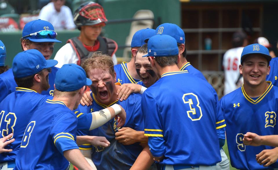 Clear Spring's Logan Helzer, middle, shows some emotion as he receives a hero's welcome after hitting a three-run home run in the fourth inning of the Blazers' 11-3 win in the Class 1A state baseball championship game.