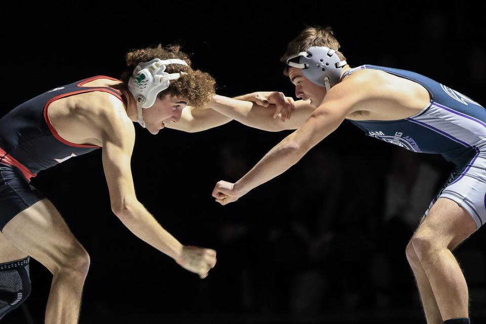 Holliston's Zak Robinson (senior) wrestles Bellingham's Ryan Cochran, right, in the 138-pound class at Holliston High School on Jan. 10, 2024.