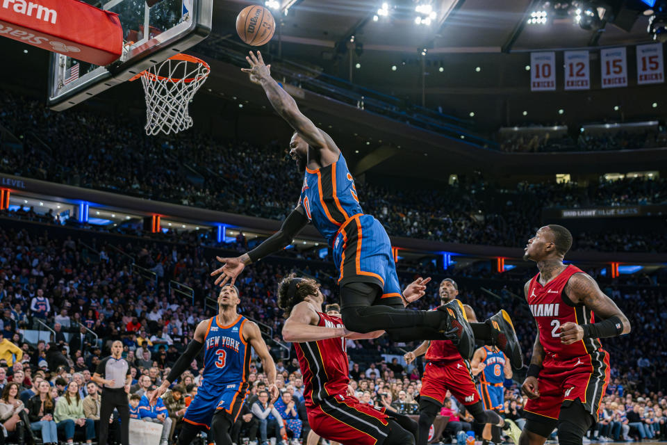 New York Knicks forward Julius Randle, top, is fouled by Miami Heat guard Jaime Jaquez Jr., center left during the second half of an NBA basketball game on Saturday, Jan. 27, 2024, in New York. (AP Photo/Peter K. Afriyie)