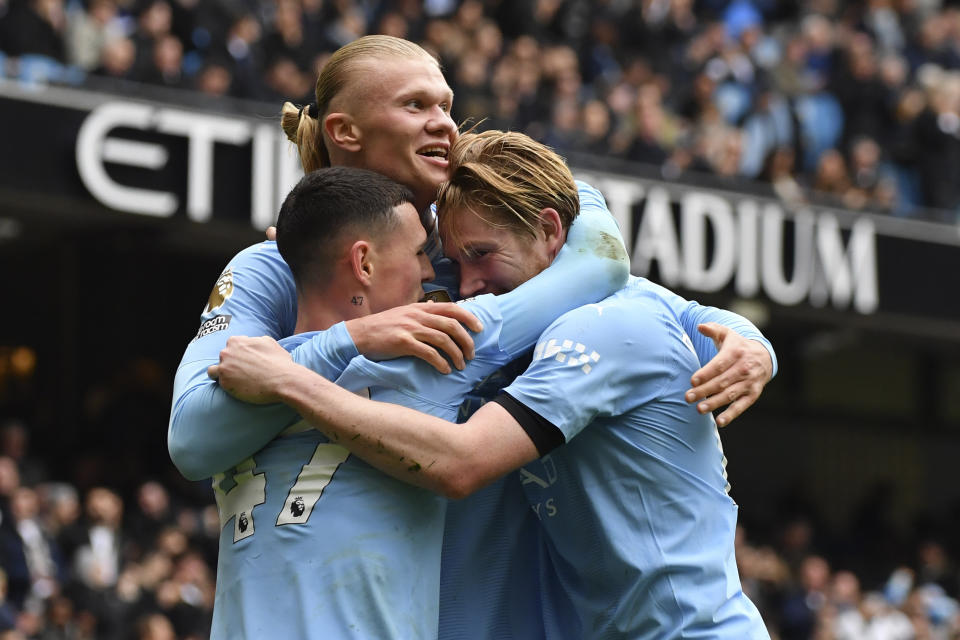 Manchester City's Erling Haaland celebrates with his teammates after scoring his side's second goal during the English Premier League soccer match between Manchester City and and Everton, at the Etihad stadium in Manchester, England, Saturday, February 10, 2024. (AP Photo/Rui Viera)