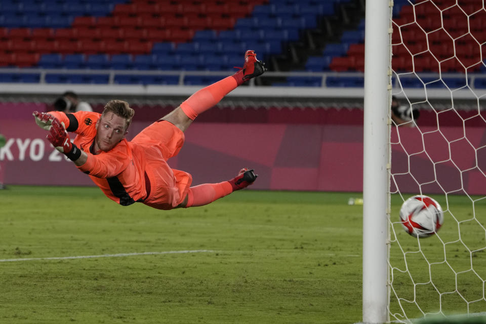 Germany's goalkeeper Florian Mueller fails to stop Brazil's Richarlison scoring his side's third goal during a men's soccer match at the 2020 Summer Olympics, Thursday, July 22, 2021, in Yokohama, Japan. (AP Photo/Kiichiro Sato)