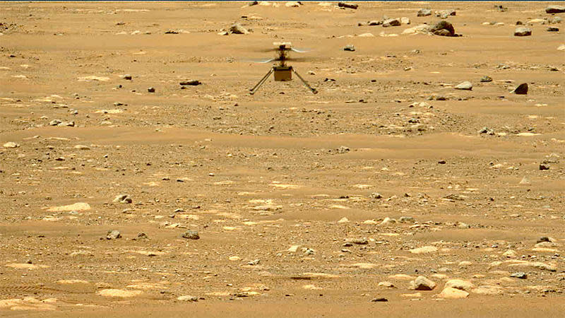An image relayed back to Earth through the Perseverance Mars rover shows the Ingenuity helicopter hovering above Jezero Crater during its second flight test Thursday. Three more flights are planned. / Credit: NASA/JPL-Caltech/ASU/MSSS