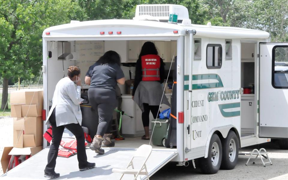 Family members meet with authorities during the search for Everette Jackson last week near Emmett, Idaho.