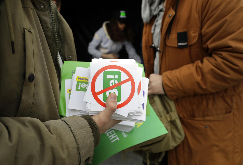 Opponents of Ukrainian comedian and presidential candidate Volodymyr Zelenskiy prepare to distribute stickers in downtown Kiev, Ukraine, Wednesday, April 17, 2019. The second round of presidential vote in Ukraine will take place on April 21. (AP Photo/Sergei Grits)