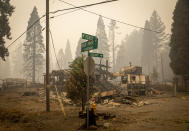 FILE - In this Sept. 15, 2020, file photo, scorched property stands at an intersection in Blue River, Ore., days after a blaze known as the Holiday Farm Fire swept through the area's business district. Oregonians are grieving the loss of some of their most treasured natural places after wildfires wiped out campgrounds, hot springs and wooded retreats that have been a touchstone for generations in a state known for its unspoiled beauty. (Andy Nelson/The Register-Guard via AP, Pool, File)