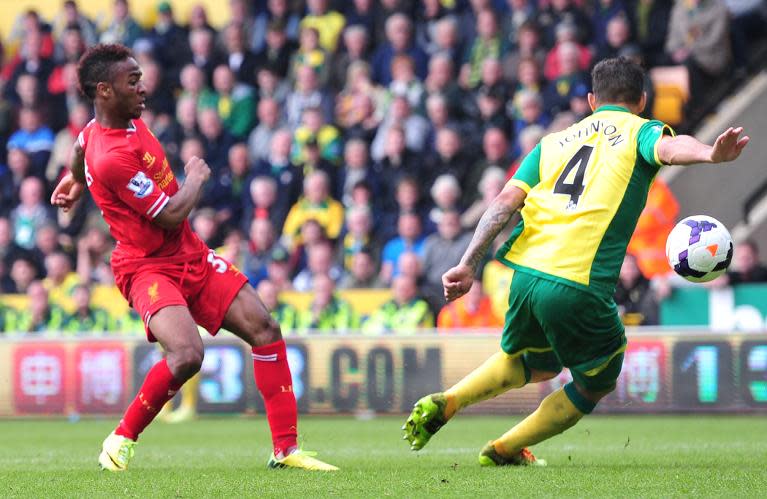 Liverpool's 19-year-old midfielder Raheem Sterling (L) scores his second goal during his side's English Premier League match against Norwich City at Carrow Road in Norwich on April 20, 2014 RESTRICTED TO EDITORIAL USE. No use with unauthorized audio, video, data, fixture lists, club/league logos or “live” services. Online in-match use limited to 45 images, no video emulation. No use in betting, games or single club/league/player publications