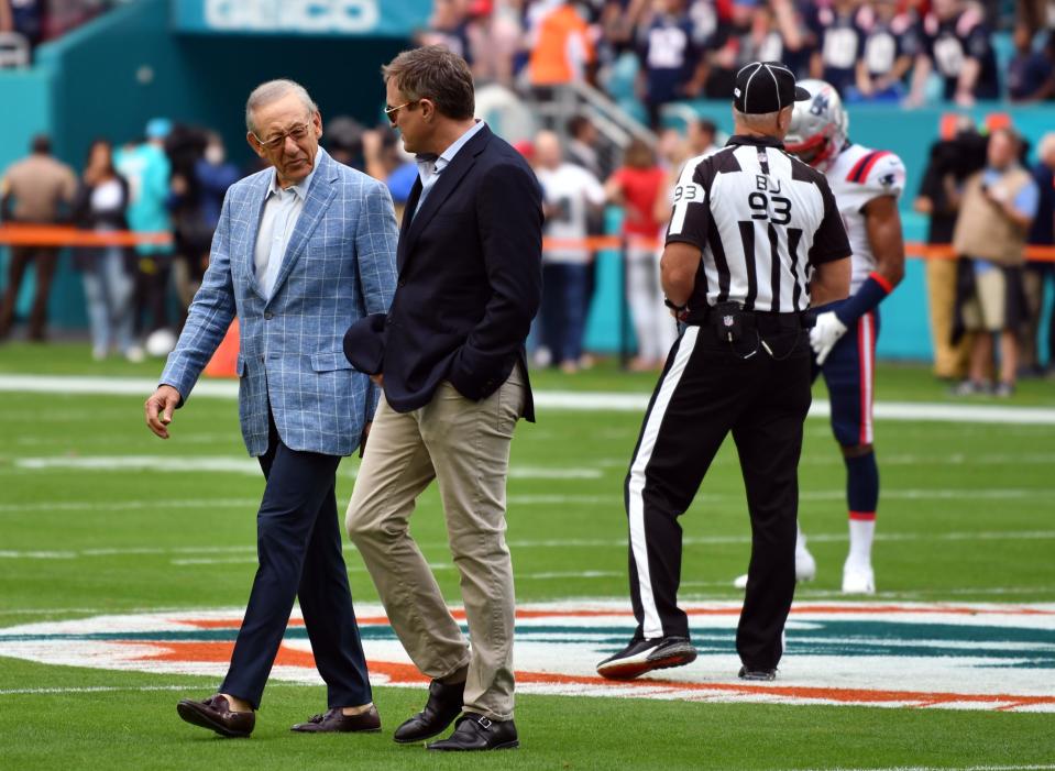 Dolphins owner Stephen Ross, left, and team president and CEO Tom Garfinkel walk to the sidelines before Sunday's game at Hard Rock Stadium. Ross said it will be up to the new coach to decide who will be Miami's starting quarterback.